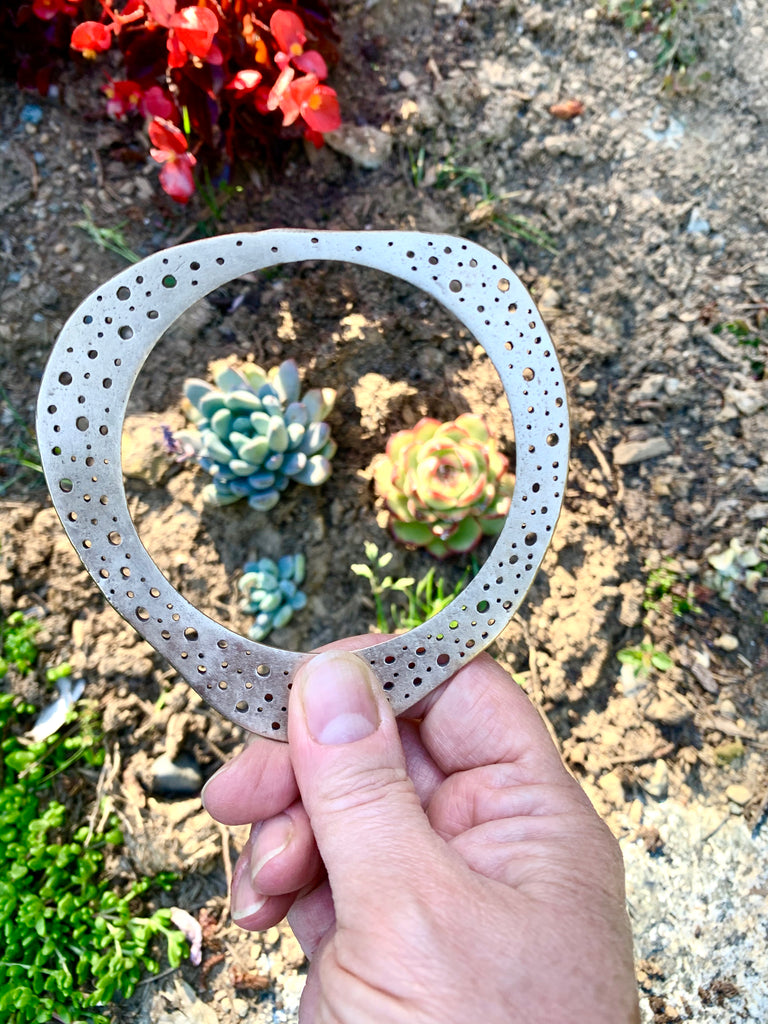 Bronze hand carved bangle framing succulents