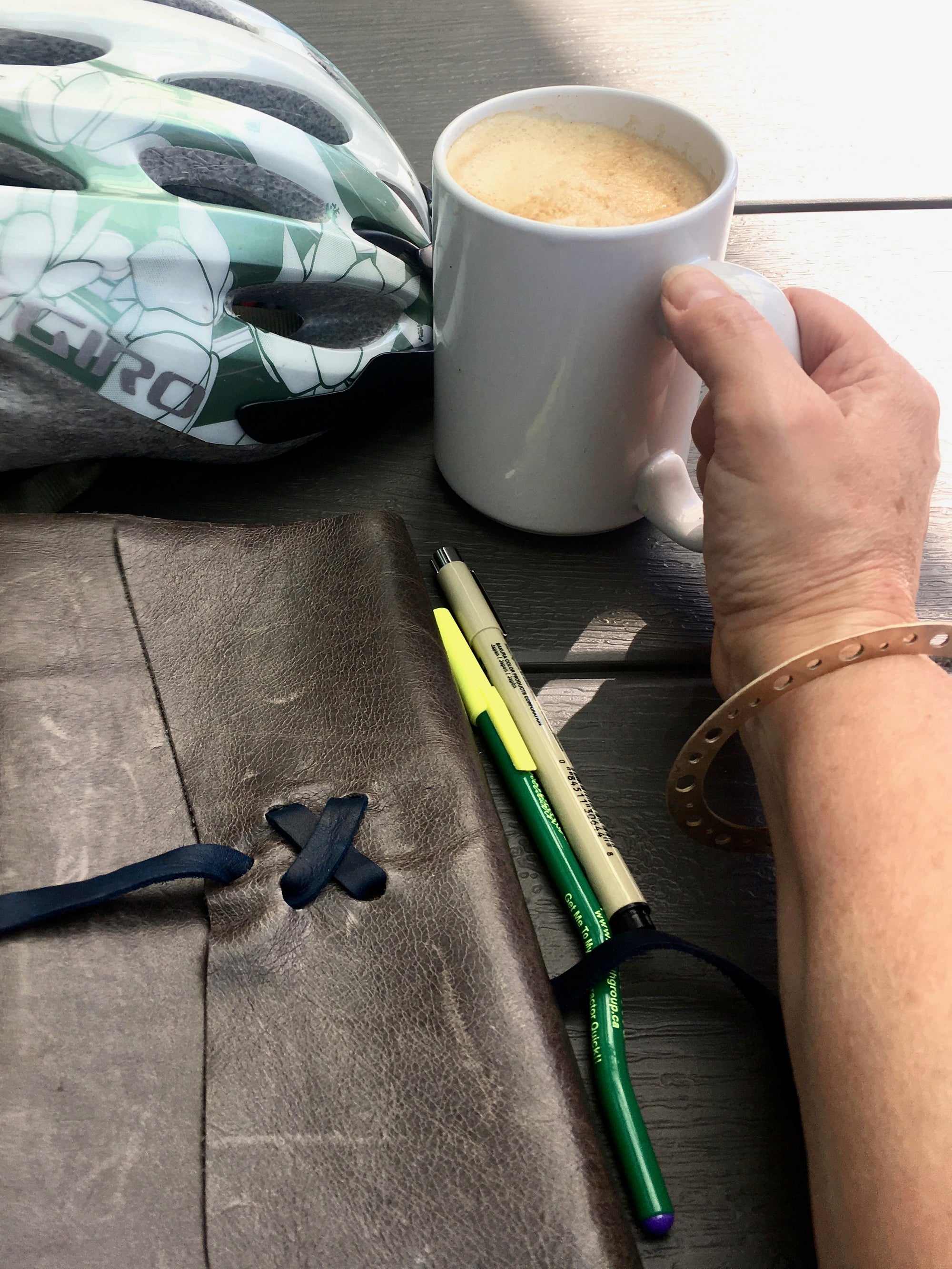 Bronze bangle and coffee shop journaling