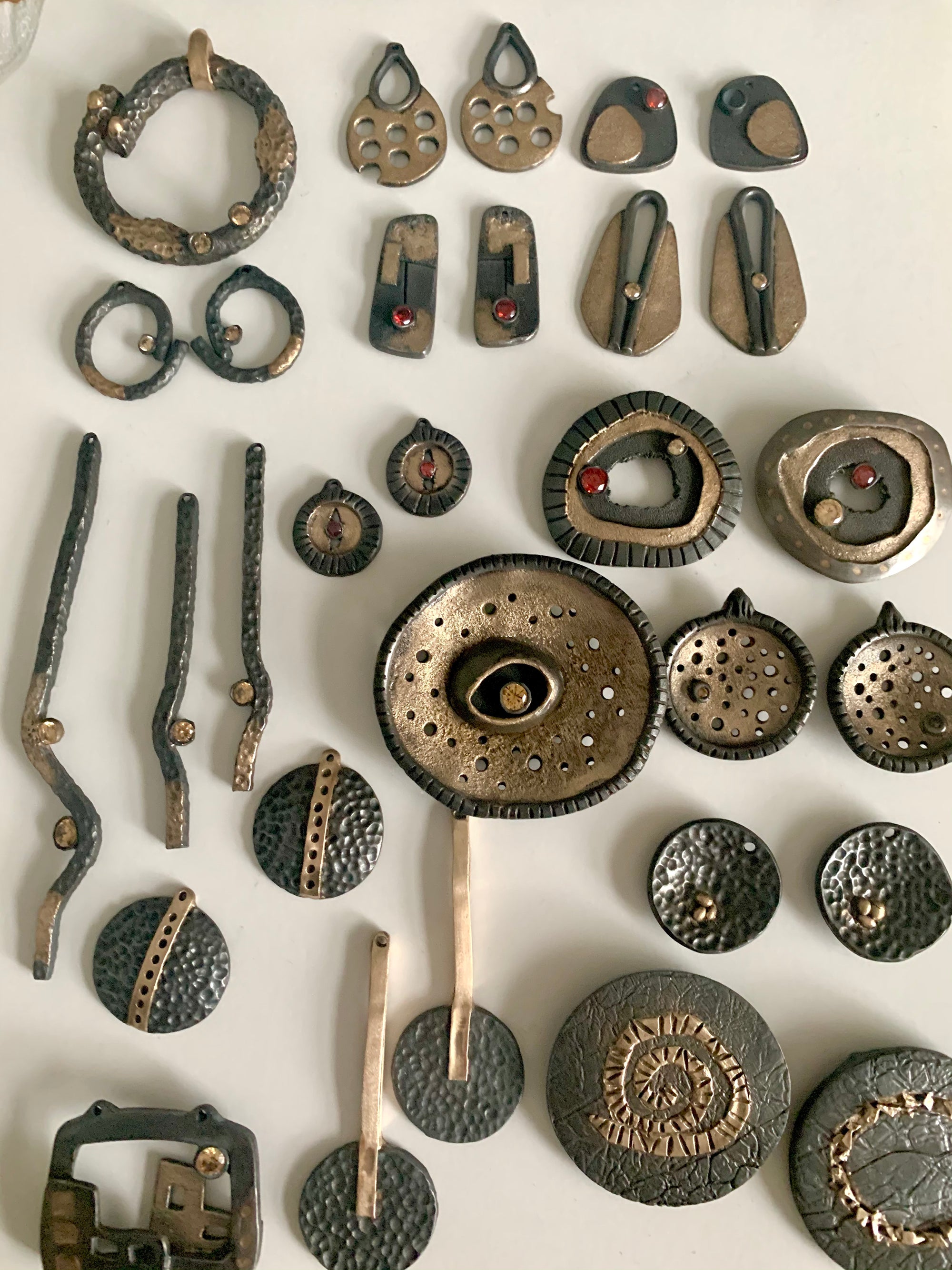 Artisan made steel and bronze jewelry pieces