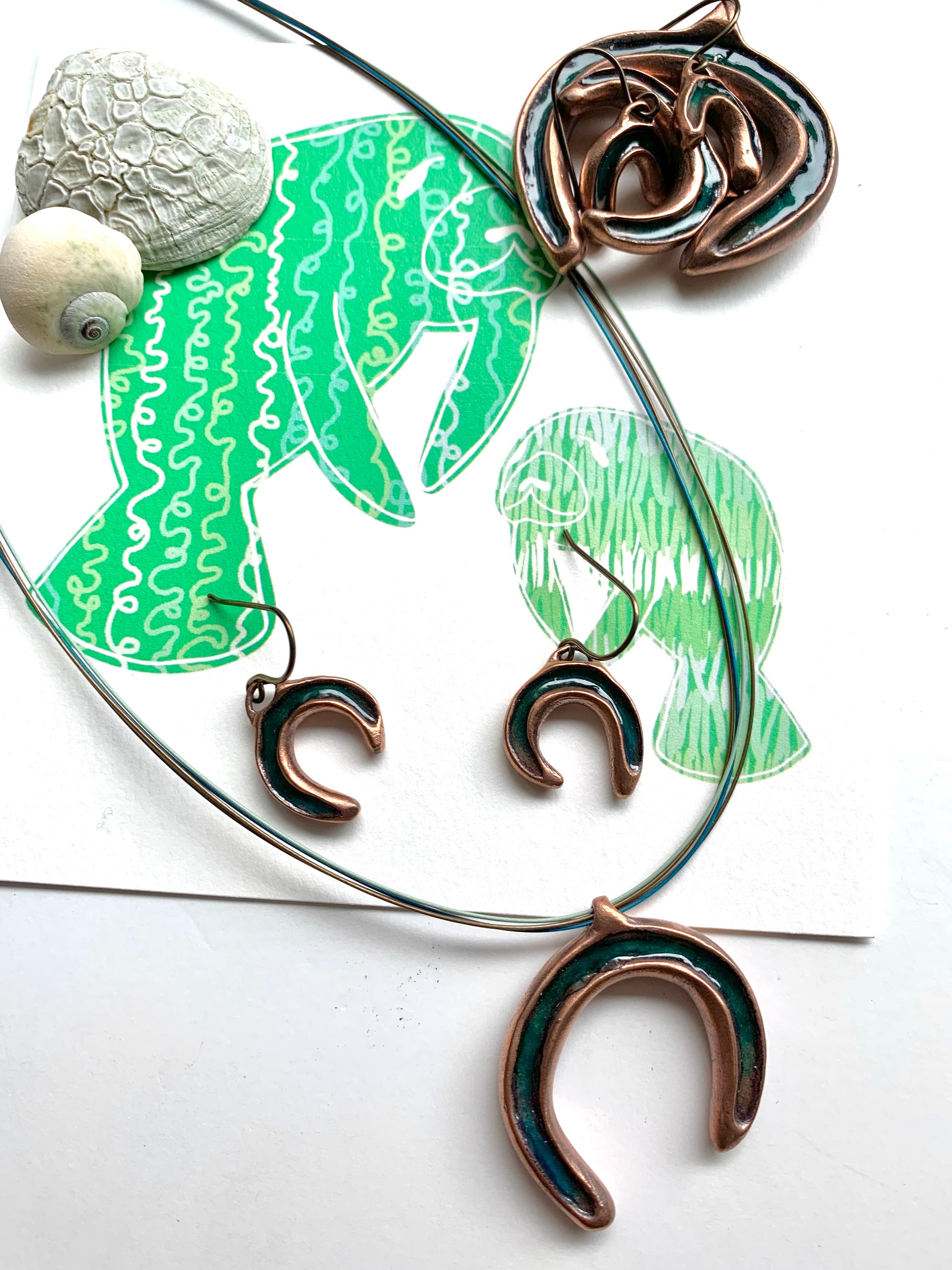 Manatees with ocean green copper jewelry