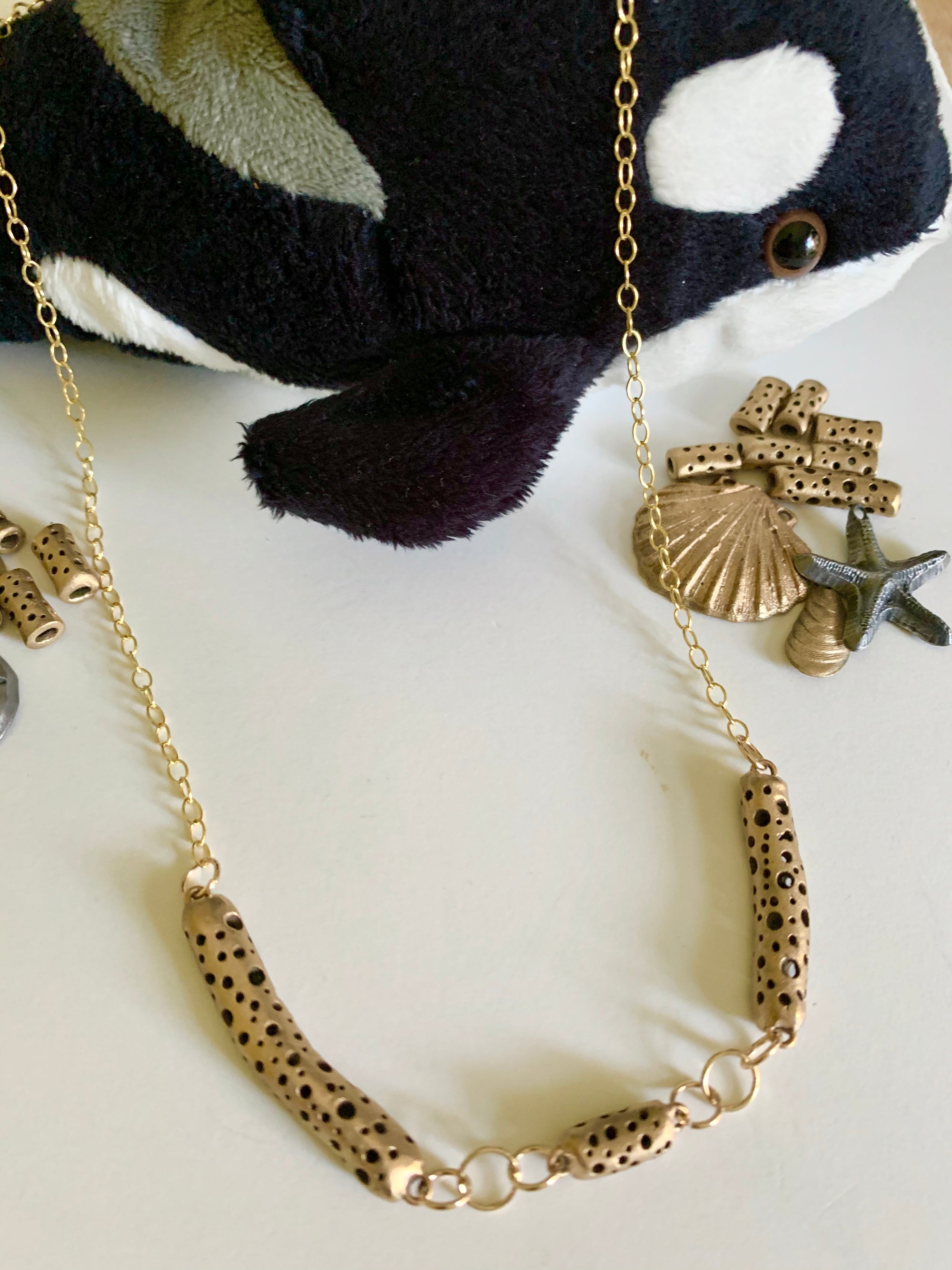 It's a whale of a {bronze} necklace